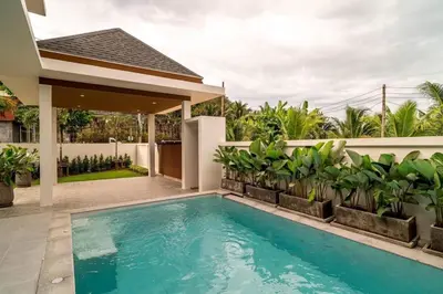 a swimming pool in the backyard of a house at MODERN NEW RELAX VILLA SoL & PooL in Nai Yang Beach