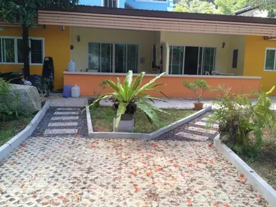 a house with a garden in front of it at Kathu Waterfall Bungalow in Kathu