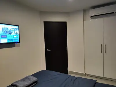 a bedroom with a bed and a flat screen tv at Chalong Bay - One bedroom on 7 Floor at Tower 1 in Ban Klang