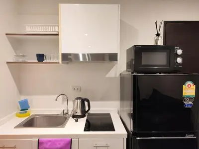 a small kitchen with a sink and a microwave at Chalong Bay - One bedroom on 7 Floor at Tower 1 in Ban Klang