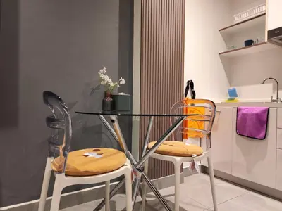a glass table and two chairs in a kitchen at Chalong Bay - One bedroom on 7 Floor at Tower 1 in Ban Klang