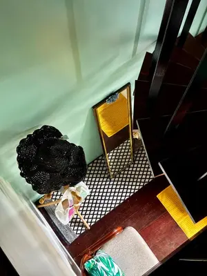 a room with a table and a chair and a mirror at Village 40 Phuket Old Town in Phuket Town