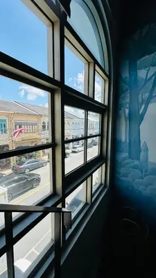 a room with a window with a view of a street at Village 40 Phuket Old Town in Phuket Town