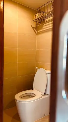 a bathroom with a white toilet in a room at Village 40 Phuket Old Town in Phuket Town
