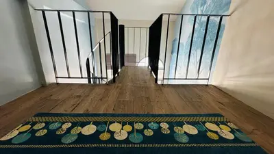 a stairway with a rug with footprints on it at Village 40 Phuket Old Town in Phuket Town