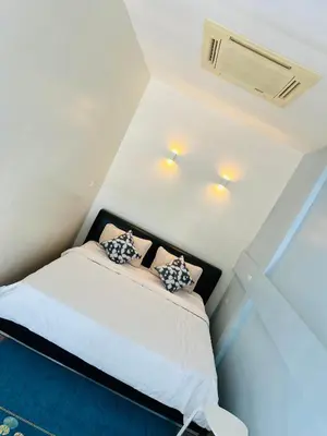 a bedroom with a bed with two pillows on it at Village 40 Phuket Old Town in Phuket Town