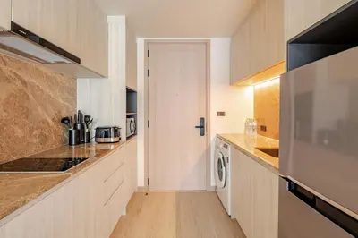 a kitchen with a washer and dryer at The Ozone Condominium 514 one bedroom in Laguna Phuket