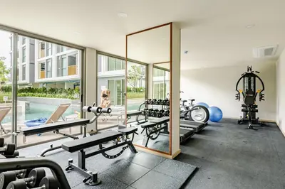 a gym with several treadmills and a mirror at The Ozone Condominium 514 one bedroom in Laguna Phuket