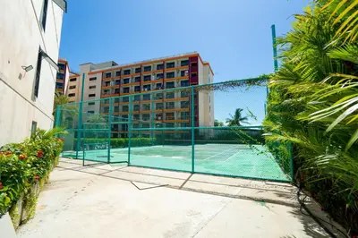 a tennis court in front of a building at North Gate Apartments in Ban Mai Salae