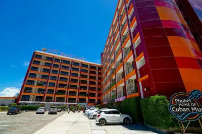 a large building with cars parked in a parking lot at North Gate Apartments in Ban Mai Salae