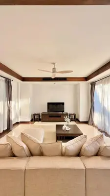 a living room with a large couch and a table at Phuket Cozy Villa Pasak4 Green Garden BangTao in Laguna Phuket