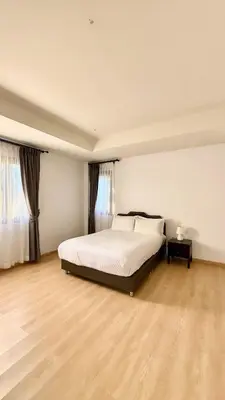a bedroom with a white bed and a wooden floor at Phuket Cozy Villa Pasak4 Green Garden BangTao in Laguna Phuket