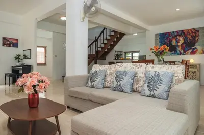 a living room with a couch and a table at Naiharn Beach Holiday Villa, Rawai Phuket in Rawai Beach