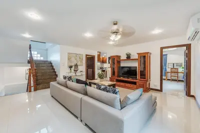 a living room with a couch and a table at Family Sea View Holiday Pool Villa, Saiyuan Phuket in Ban Saiyuan (1)
