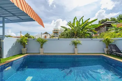 a swimming pool on the side of a building at Family Sea View Holiday Pool Villa, Saiyuan Phuket in Ban Saiyuan (1)