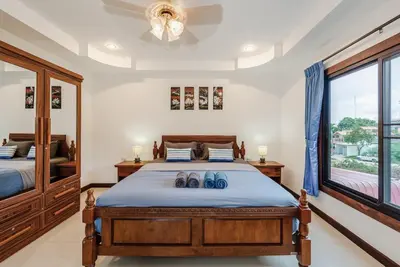 a bedroom with a large bed with two shoes on it at Family Sea View Holiday Pool Villa, Saiyuan Phuket in Ban Saiyuan (1)