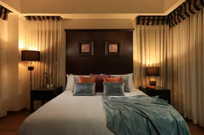 a bedroom with a large bed with pillows at Laguna Golf View Pool Villa in Ban Thalat Choeng Thale