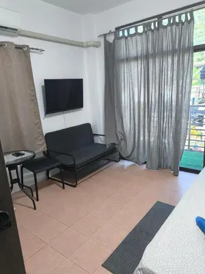 a living room with a tv and a couch and a chair at Kata beach weivs in Kata Beach