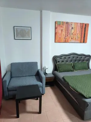 a bedroom with a bed and a couch and a chair at Kata beach weivs in Kata Beach