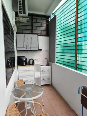 a small kitchen with a glass table and chairs at Kata beach weivs in Kata Beach