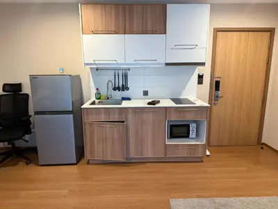a kitchen with a refrigerator and a microwave at Title 5 in Rawai Beach