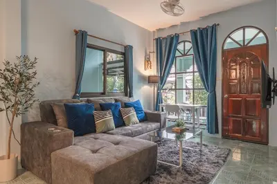 a living room with a couch and a table at Areca Holiday Home 3, Karon Beach in Karon Beach