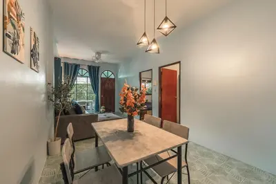 a dining room with a table and chairs at Areca Holiday Home 3, Karon Beach in Karon Beach