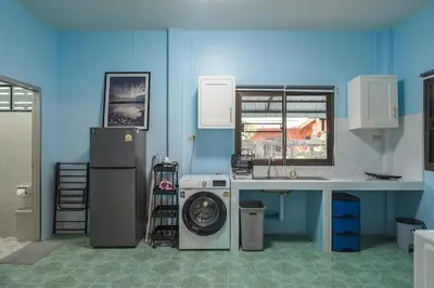 a kitchen with a washer and a washing machine at Areca Holiday Home 3, Karon Beach in Karon Beach