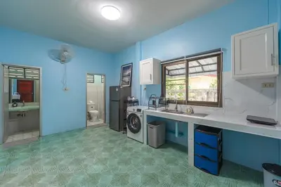 a blue kitchen with a sink and a washing machine at Areca Holiday Home 3, Karon Beach in Karon Beach