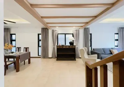 a living room with a blue couch and a table at 3 Bedroom Renovated Villa 3 minutes to the beach in Karon Beach