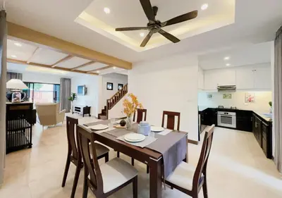 a dining room and kitchen with a table and chairs at 3 Bedroom Renovated Villa 3 minutes to the beach in Karon Beach