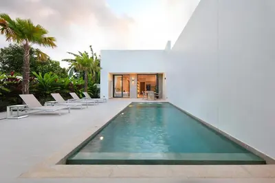a swimming pool in the middle of a house at Luxury Modern Villa Phuket - Thala in Phuket