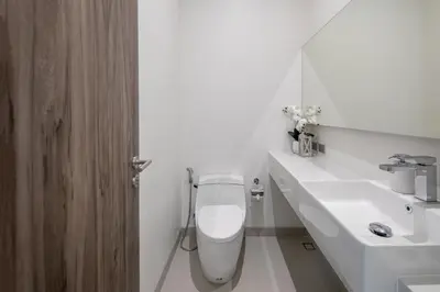 a white bathroom with a toilet and a sink at Luxury Modern Villa Phuket - Thala in Phuket