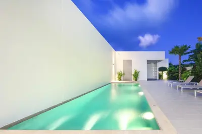 a swimming pool in front of a house at Luxury Modern Villa Phuket - Thala in Phuket