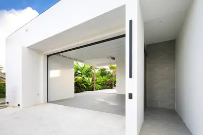 an open door to a house with white walls at Luxury Modern Villa Phuket - Thala in Phuket