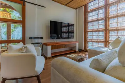 a living room with white furniture and a flat screen tv at Private Designer Villa with Pool Prime Rawai 3 beds in Ban Saiyuan (1)