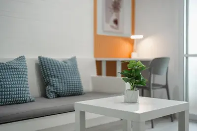 a living room with a white table and a couch at A Stylish Condo in Local Area Kathu, Phuket in Kathu