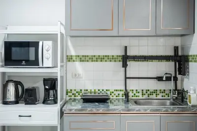 a kitchen with a sink and a microwave at A Stylish Condo in Local Area Kathu, Phuket in Kathu