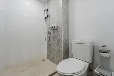 a bathroom with a white toilet and a shower at A Stylish Condo in Local Area Kathu, Phuket in Kathu