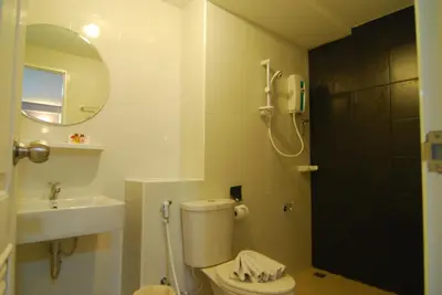 a bathroom with a toilet and a sink at Leelawadee Naka in Phuket Town