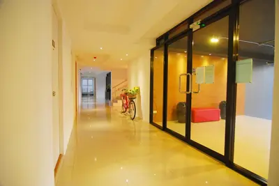 a hallway with glass doors and a bike in a building at Leelawadee Naka in Phuket Town