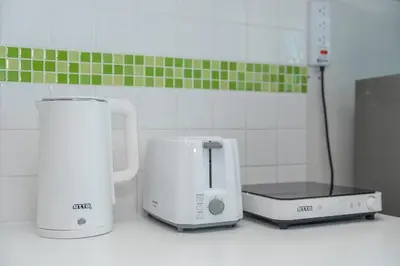 two appliances sitting on a counter in a kitchen at A Nice Condo in Local Livelyhood of Kathu in Kathu