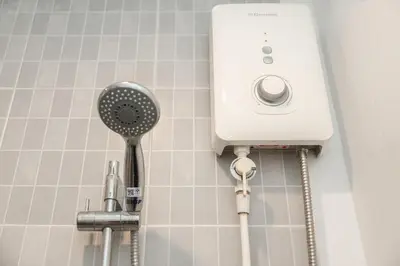 a bathroom with a shower with a hair dryer at A Nice Condo in Local Livelyhood of Kathu in Kathu