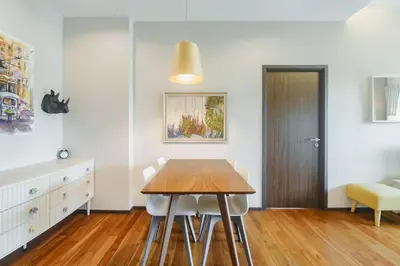 a dining room with a wooden table and a bedroom at D401 Title Rawai Beach Front 2 Bedroom Apartment in Rawai Beach