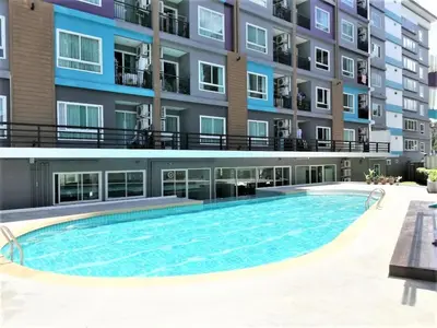 a swimming pool in front of a building at A Fully Furnished Condo in the Phuket Center in Ban Ket Ho