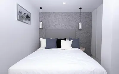 a bedroom with a large white bed with blue pillows at апартаменты с двумя спальнями in Karon Beach