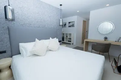 a bedroom with a white bed with white pillows at апартаменты с двумя спальнями in Karon Beach