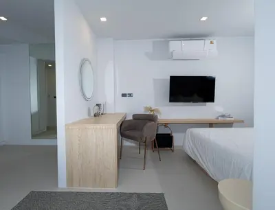 a bedroom with a desk and a bed and a mirror at апартаменты с двумя спальнями in Karon Beach