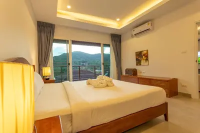 a bedroom with a large bed with a large window at C126 Walk to Beach Global & Local Eats Pool & Gym in Rawai Beach