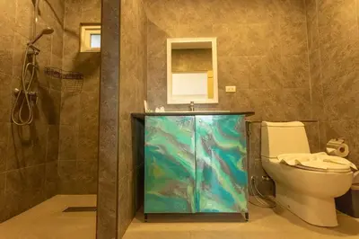 a bathroom with a fish tank next to a toilet at C126 Walk to Beach Global & Local Eats Pool & Gym in Rawai Beach